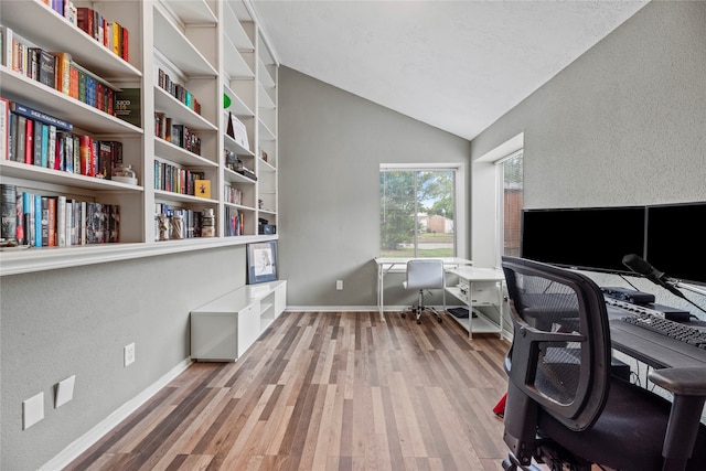 office with wood-type flooring and lofted ceiling