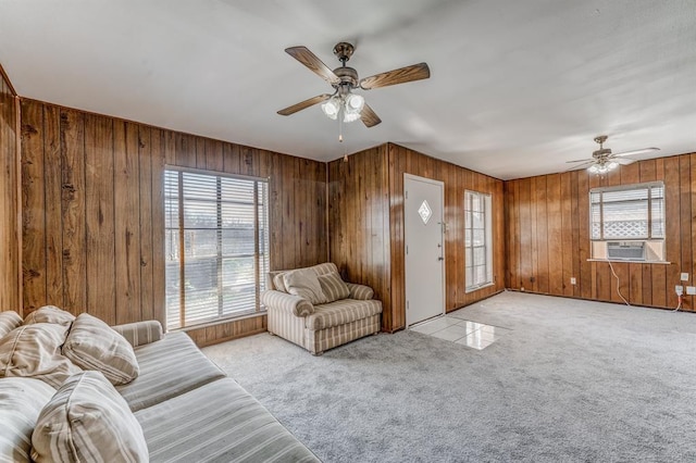 unfurnished living room with ceiling fan and wood walls