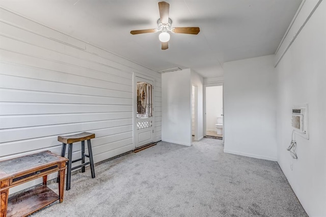 empty room with ceiling fan and light colored carpet