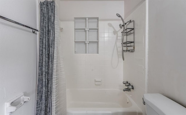 bathroom with toilet and shower / tub combo