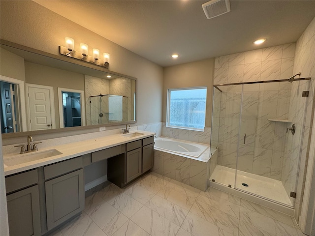 bathroom with vanity and separate shower and tub