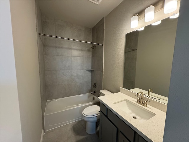 full bathroom with tiled shower / bath, vanity, toilet, and tile patterned floors