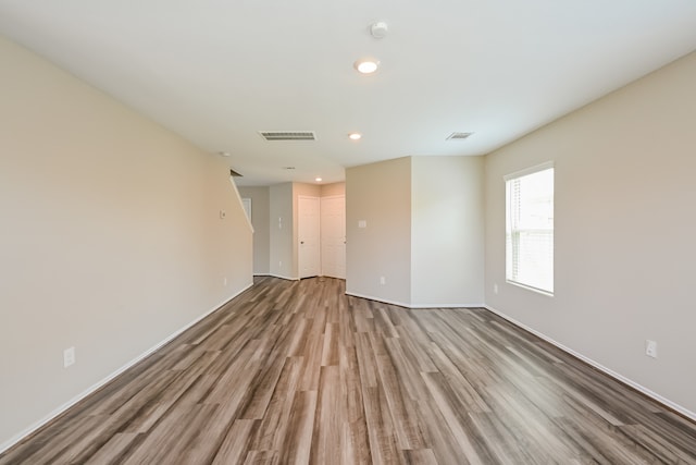 unfurnished room with light wood-type flooring