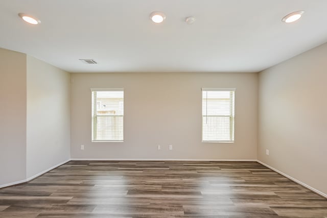 spare room featuring dark hardwood / wood-style floors