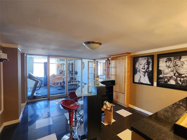 interior space with french doors and a textured ceiling