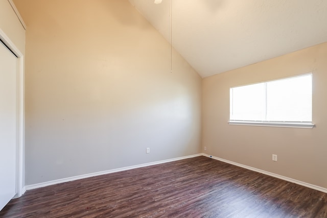 unfurnished room featuring dark hardwood / wood-style flooring and high vaulted ceiling