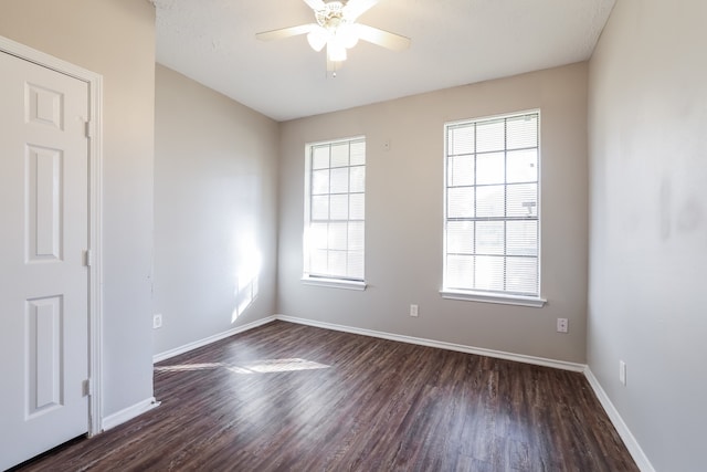 unfurnished room with ceiling fan and dark hardwood / wood-style flooring