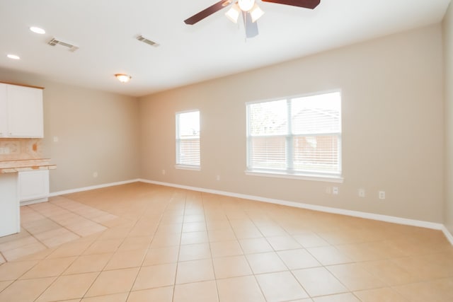 unfurnished living room with light tile patterned floors and ceiling fan