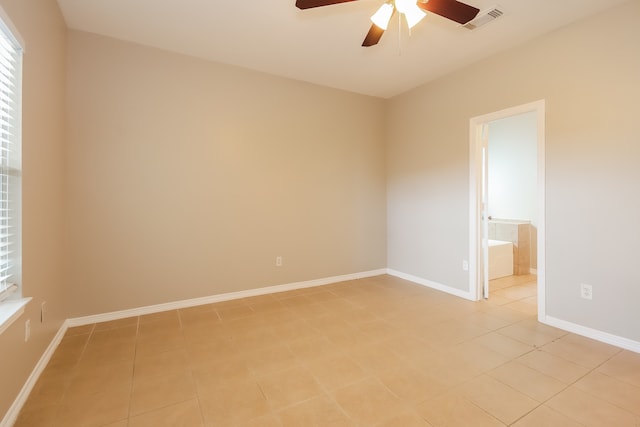 unfurnished room with ceiling fan and light tile patterned flooring