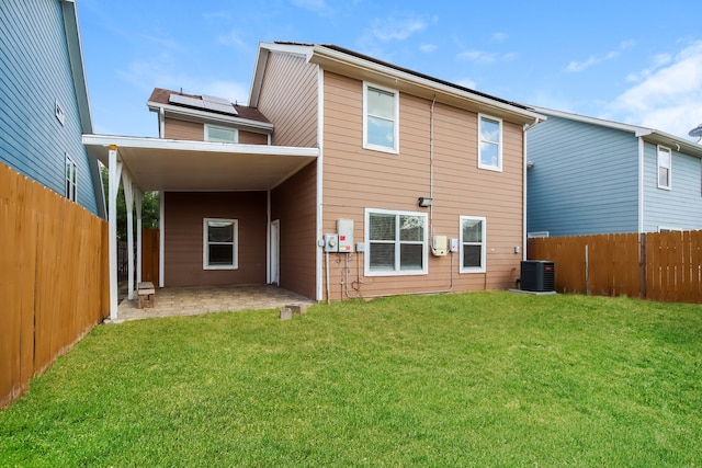 rear view of house featuring a lawn and a patio