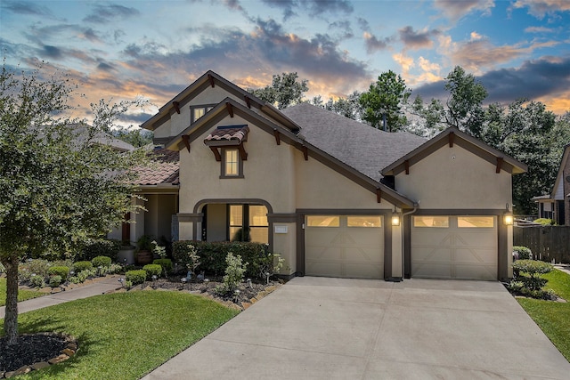 view of front of house featuring a garage and a yard