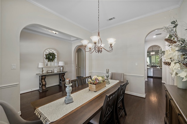 dining room with ornamental molding, dark hardwood / wood-style flooring, and a notable chandelier