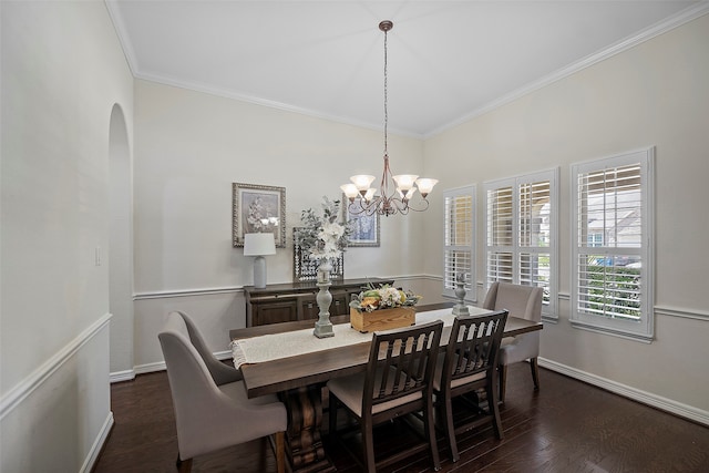 dining room featuring ornamental molding, dark wood-type flooring, and a notable chandelier