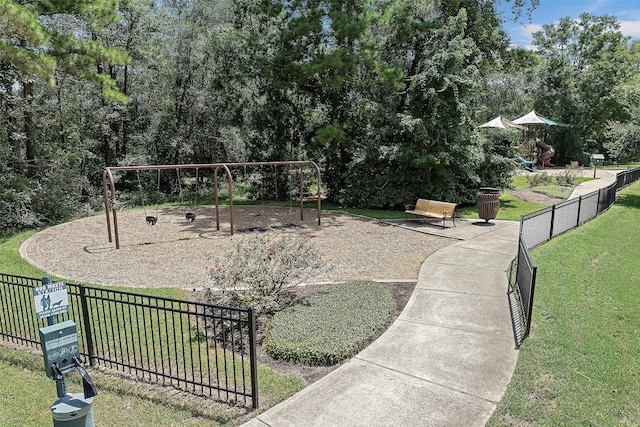 surrounding community featuring a playground and a yard