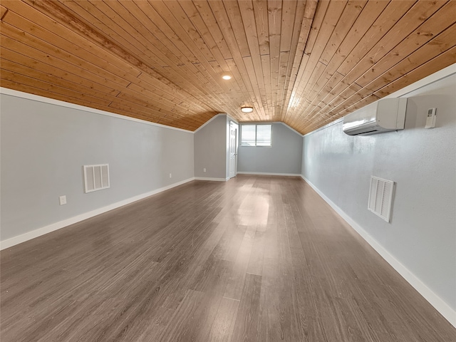 additional living space featuring an AC wall unit, dark hardwood / wood-style flooring, wooden ceiling, and vaulted ceiling