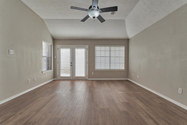 empty room with ceiling fan, french doors, wood-type flooring, a textured ceiling, and lofted ceiling