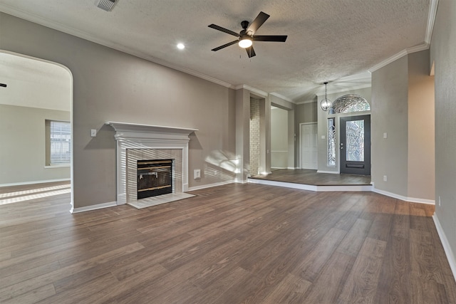 unfurnished living room with hardwood / wood-style flooring, crown molding, and a wealth of natural light