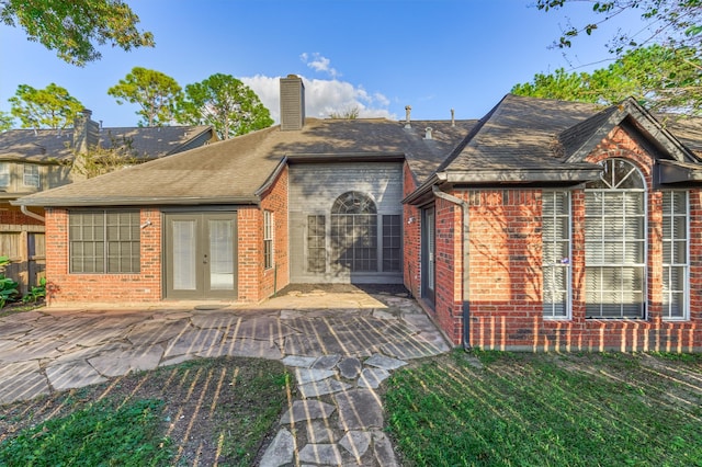 rear view of property featuring french doors and a patio area