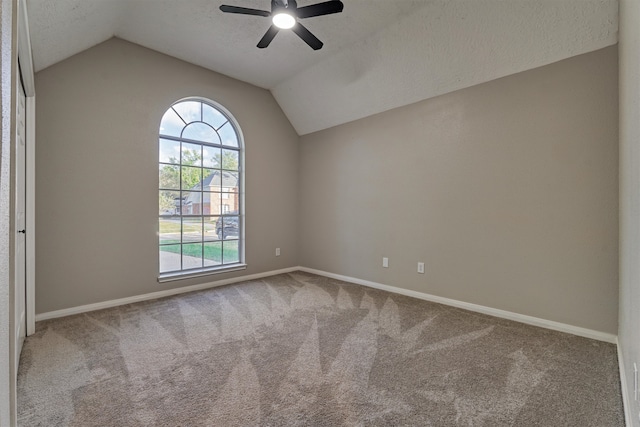 unfurnished room with carpet floors and vaulted ceiling