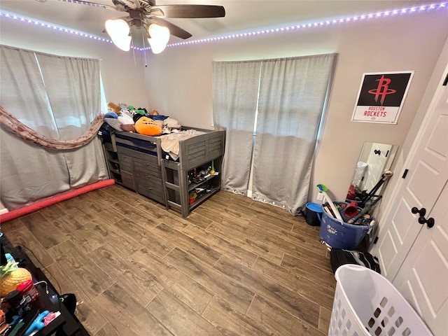 bedroom with ceiling fan and hardwood / wood-style flooring