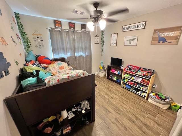 bedroom with hardwood / wood-style flooring and ceiling fan