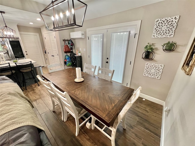 dining space featuring a wall mounted AC, dark hardwood / wood-style flooring, and french doors