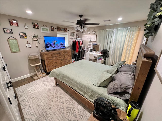 bedroom featuring wood-type flooring and ceiling fan