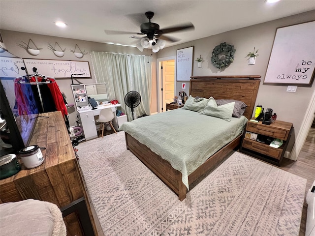 bedroom with ceiling fan and wood-type flooring