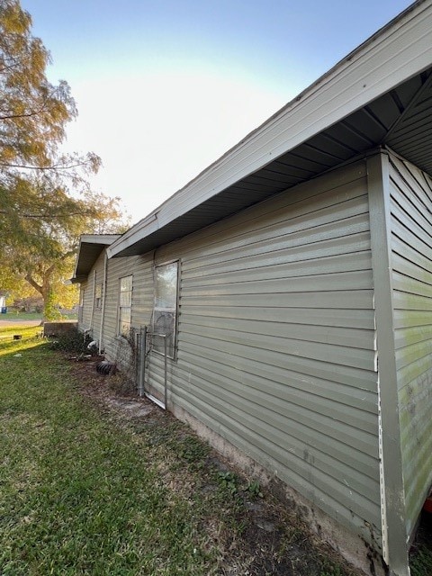 view of side of property with a yard