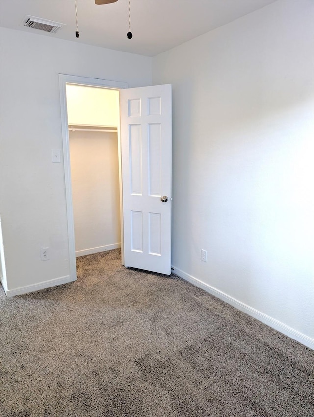 unfurnished bedroom with a closet and carpet