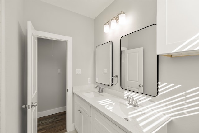 bathroom with hardwood / wood-style floors and vanity