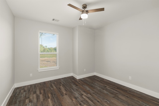 empty room featuring ceiling fan and dark wood-type flooring