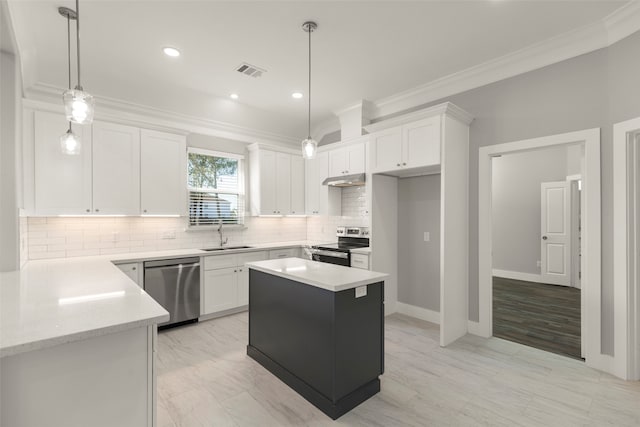 kitchen with white cabinets, stainless steel appliances, a kitchen island, and hanging light fixtures