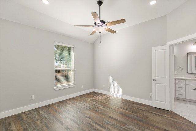 unfurnished room with ceiling fan, dark hardwood / wood-style flooring, and lofted ceiling