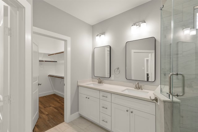 bathroom featuring hardwood / wood-style floors, vanity, and walk in shower