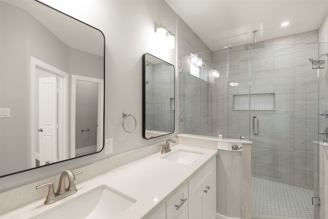 bathroom featuring vanity and an enclosed shower