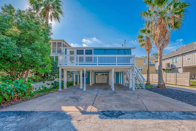 raised beach house featuring a carport