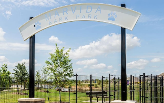 view of community featuring a yard and fence