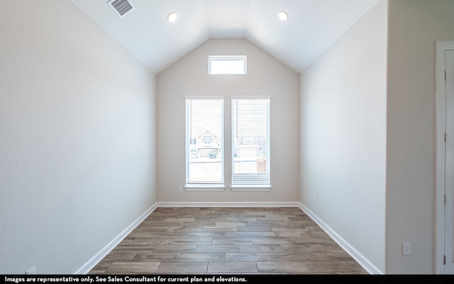 empty room featuring light hardwood / wood-style floors and lofted ceiling