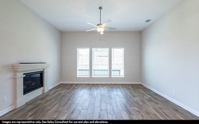 unfurnished living room with ceiling fan and wood-type flooring