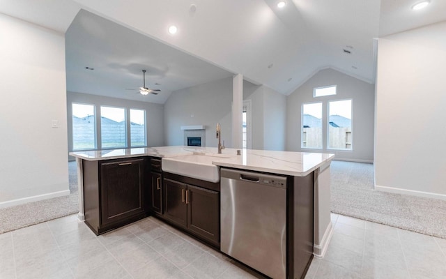 kitchen featuring light colored carpet, a sink, open floor plan, stainless steel dishwasher, and a center island with sink