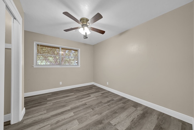 unfurnished bedroom with wood-type flooring, a closet, and ceiling fan