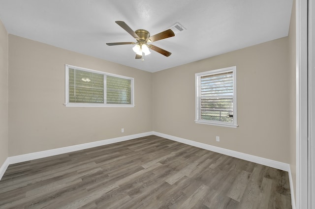 empty room featuring wood-type flooring and ceiling fan