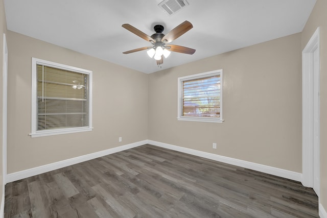 empty room with ceiling fan and dark wood-type flooring