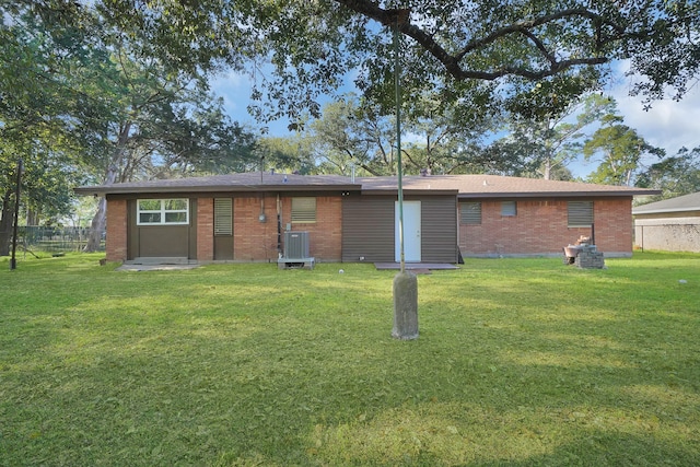 back of property with a yard and cooling unit