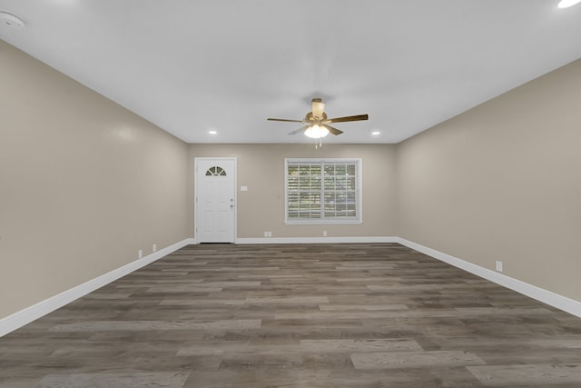 interior space with ceiling fan and dark hardwood / wood-style flooring