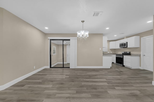 kitchen with white cabinetry, stainless steel appliances, light hardwood / wood-style flooring, a chandelier, and pendant lighting