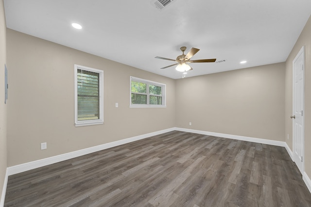 spare room featuring ceiling fan and dark hardwood / wood-style flooring