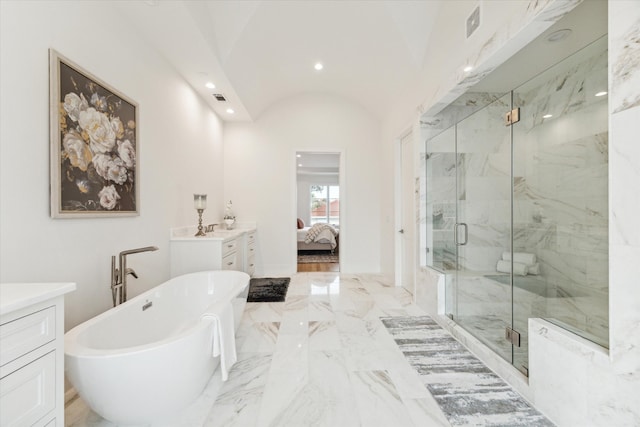 bathroom with vanity, separate shower and tub, and vaulted ceiling