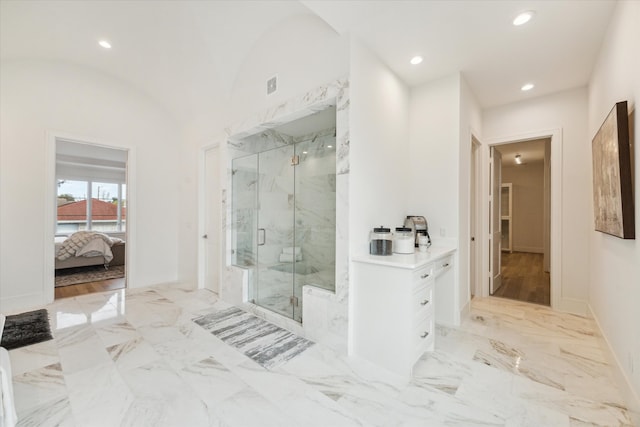 bathroom featuring a shower with door, hardwood / wood-style floors, and lofted ceiling